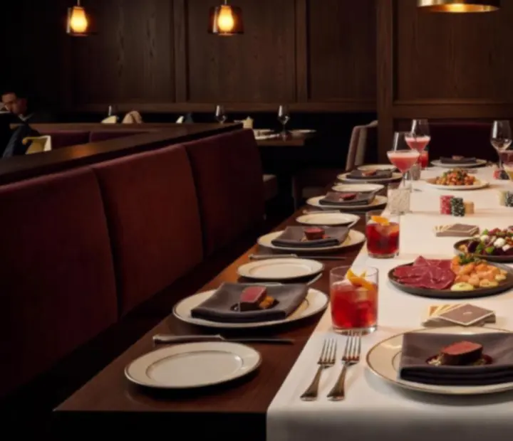 Dining table set beside an in-person poker table at Turnand Truffle