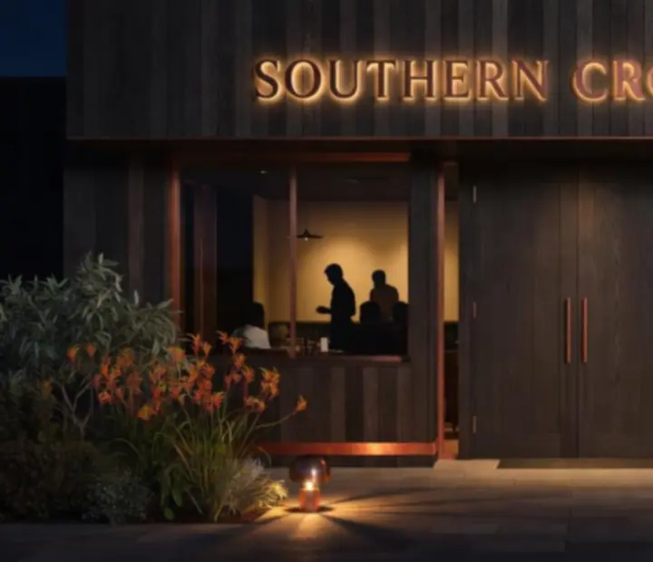 Exterior of Turnand Truffle at night with warm lighting and guests arriving