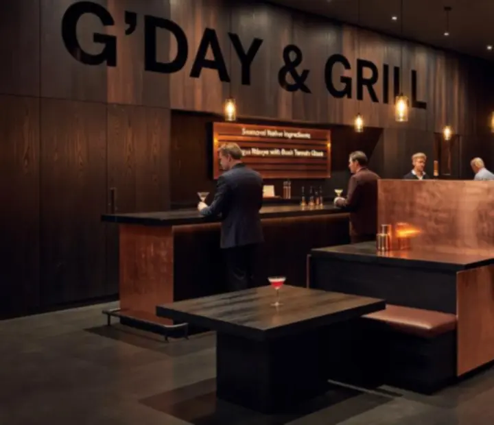 Moody restaurant interior at night with warm pendants and guests enjoying an event